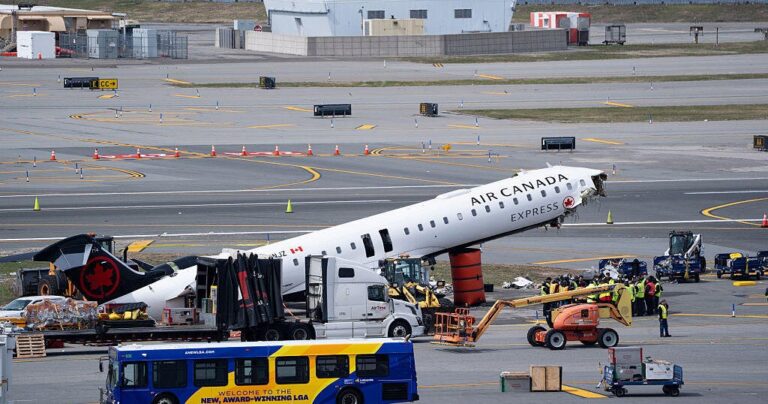 Wreckage of crashed Air Canada plane being cleared from LaGuardia Airport runway