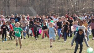 Children race to gather marshmallows dropped from a helicopter at pair of parks